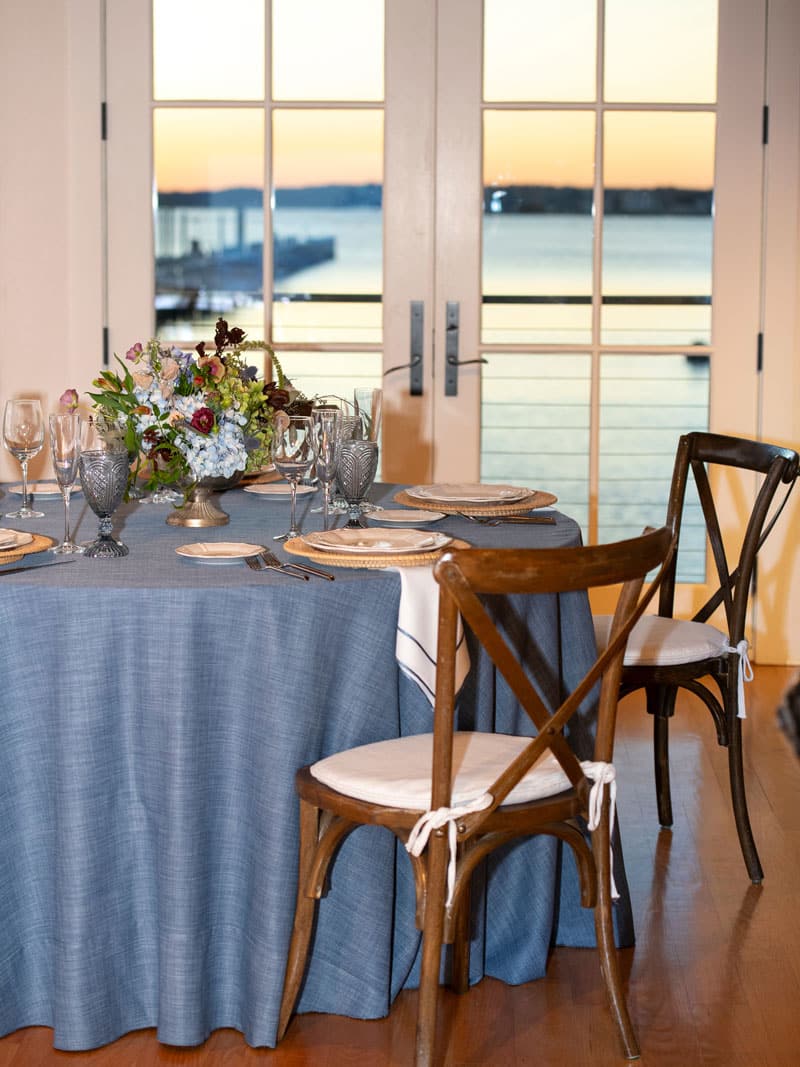 Table setting for wedding event, with the harbor visible in the background